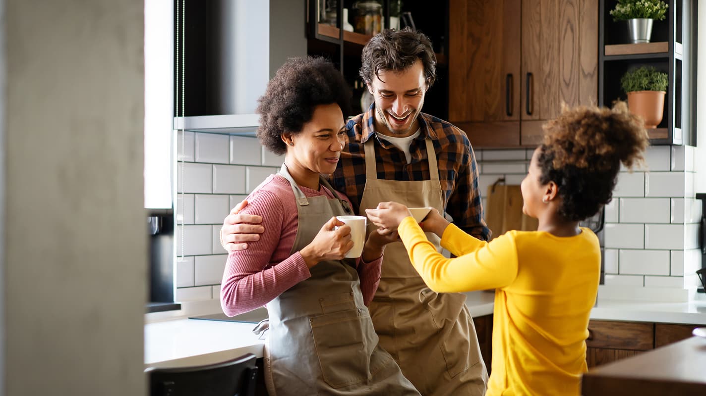 Woman writing on whiteboard with coworkers looking on
